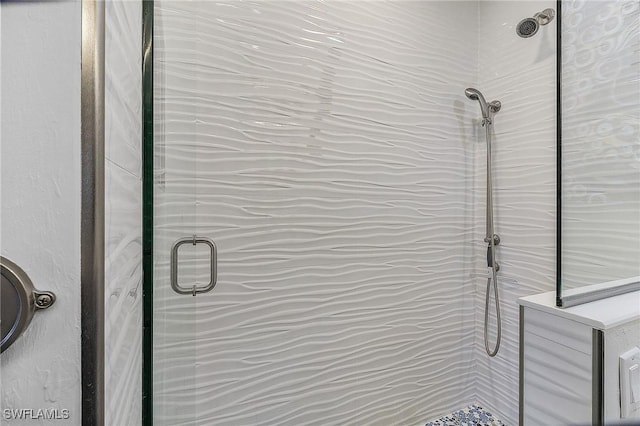 interior details with a shower with door