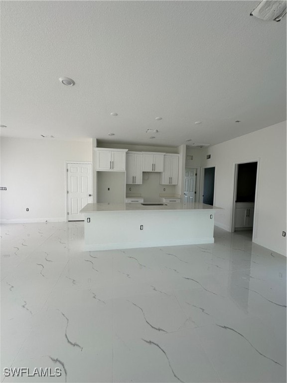 unfurnished living room featuring a textured ceiling