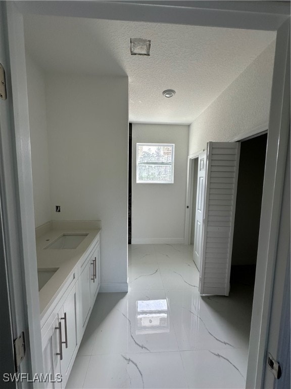 bathroom featuring vanity and a textured ceiling