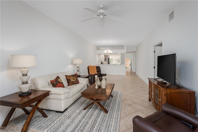 living area featuring light tile patterned flooring, visible vents, lofted ceiling, and ceiling fan with notable chandelier