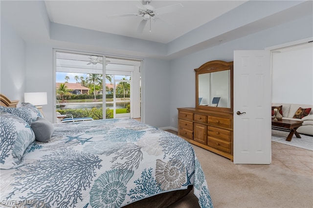 bedroom featuring light carpet, ceiling fan, and access to exterior