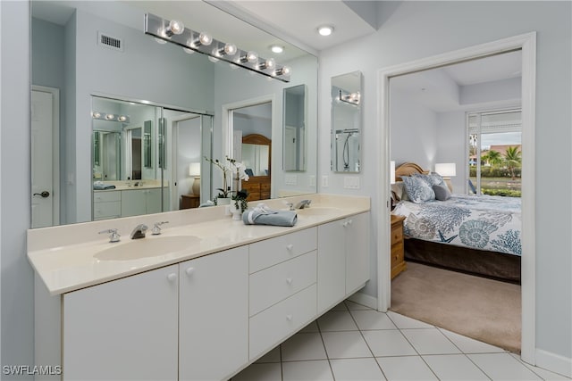 ensuite bathroom featuring ensuite bathroom, a sink, and visible vents