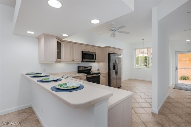 kitchen featuring stainless steel appliances, a peninsula, a sink, light countertops, and glass insert cabinets