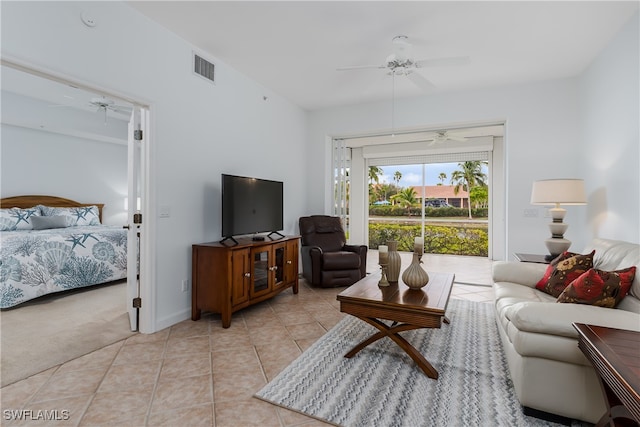 carpeted living room featuring ceiling fan