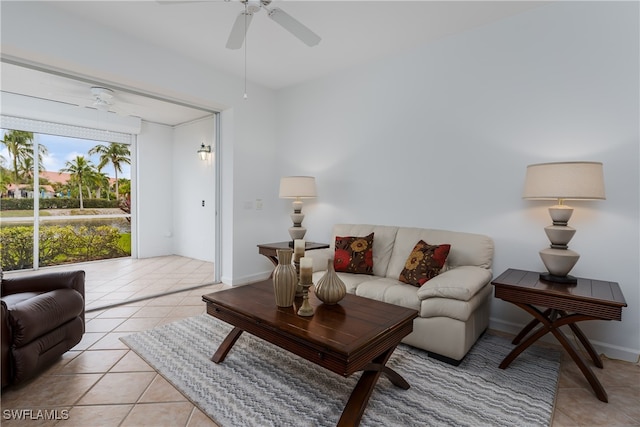 living room with ceiling fan, light tile patterned flooring, and baseboards