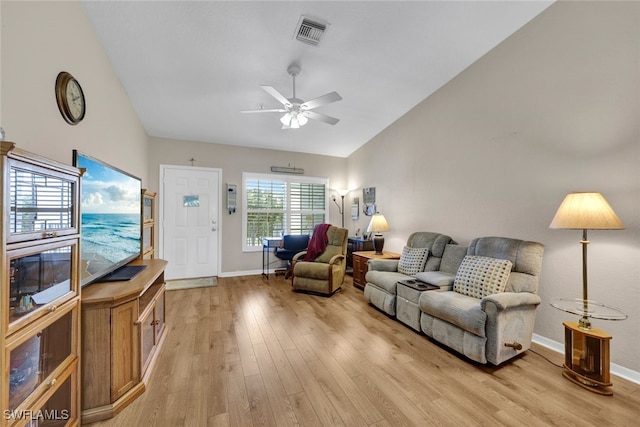 living room with light wood-type flooring, vaulted ceiling, and ceiling fan