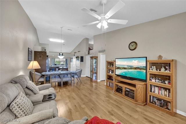 living room featuring light wood-type flooring, high vaulted ceiling, and ceiling fan