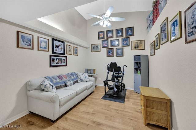 living room with light hardwood / wood-style flooring, ceiling fan, and lofted ceiling