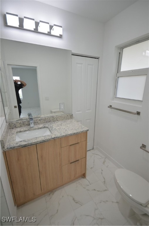 bathroom featuring vanity and toilet