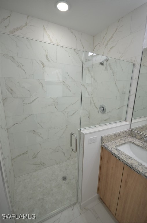 bathroom with vanity and an enclosed shower