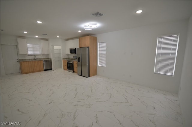 kitchen with white cabinets, sink, and stainless steel appliances