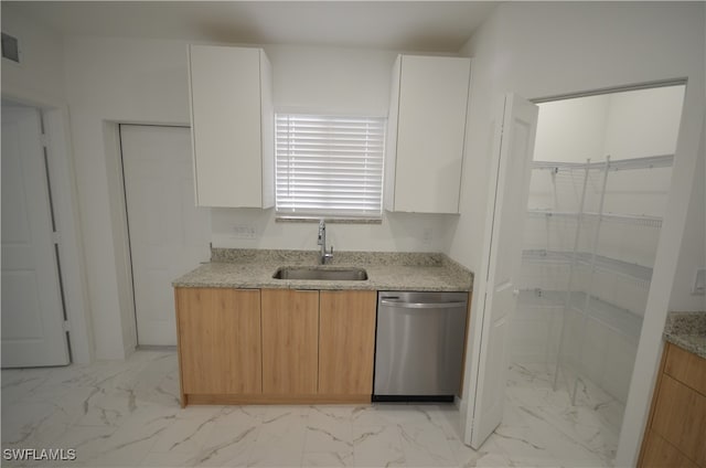 kitchen with white cabinets, dishwasher, light stone countertops, and sink