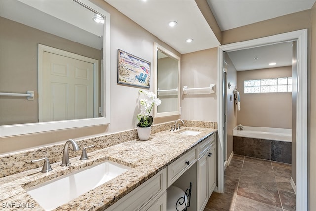 bathroom featuring vanity and tiled tub