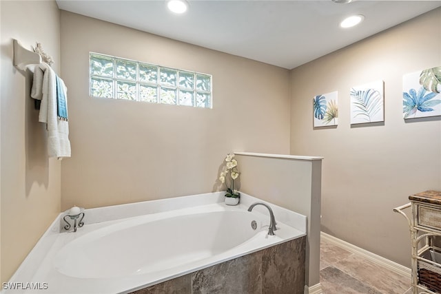 bathroom featuring a relaxing tiled tub