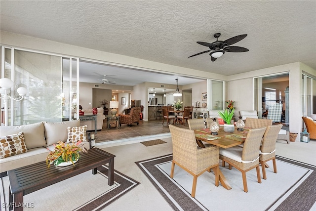 dining space with ceiling fan and a textured ceiling