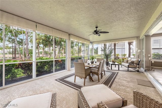 sunroom / solarium featuring ceiling fan