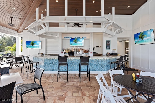 dining room featuring wooden ceiling, high vaulted ceiling, ceiling fan, and beamed ceiling