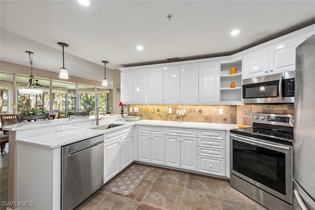 kitchen with kitchen peninsula, decorative backsplash, stainless steel appliances, sink, and white cabinetry