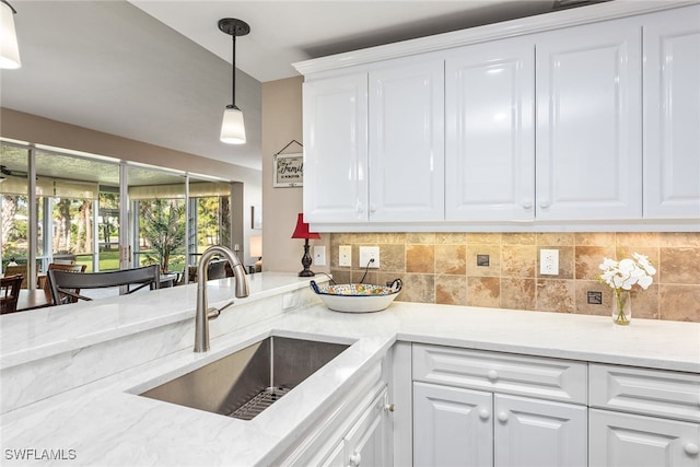 kitchen featuring white cabinetry and sink