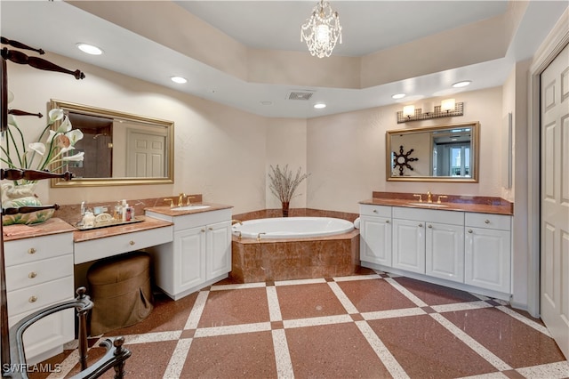 bathroom featuring vanity and tiled bath