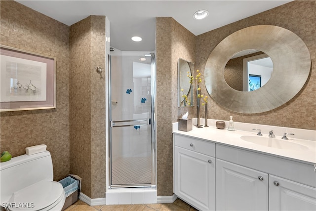 bathroom with tile patterned flooring, vanity, toilet, and walk in shower