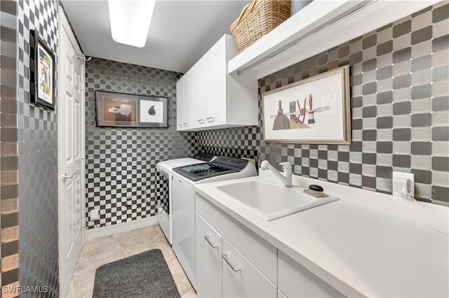 laundry room with cabinets, sink, washer and dryer, tile walls, and light tile patterned flooring