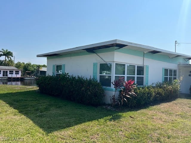 view of side of property with a yard