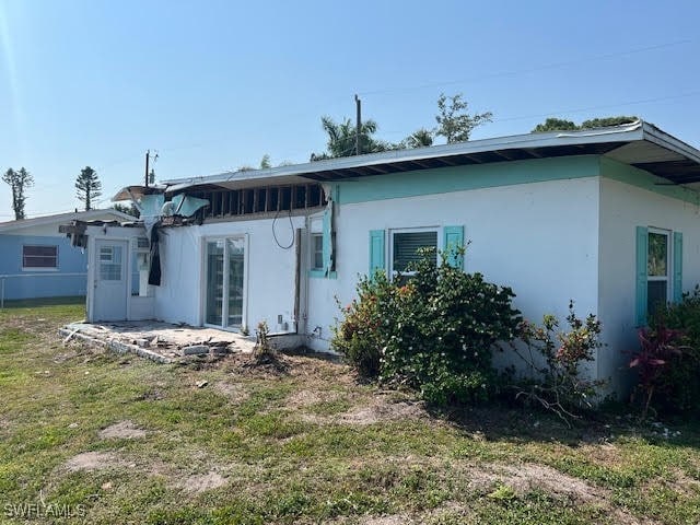 rear view of property featuring a yard