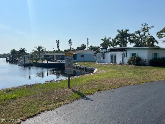 exterior space with a water view and a lawn