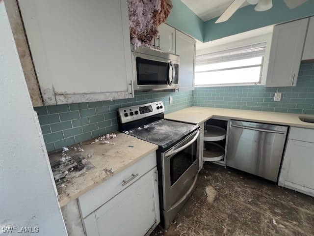 kitchen featuring ceiling fan, white cabinetry, appliances with stainless steel finishes, and tasteful backsplash