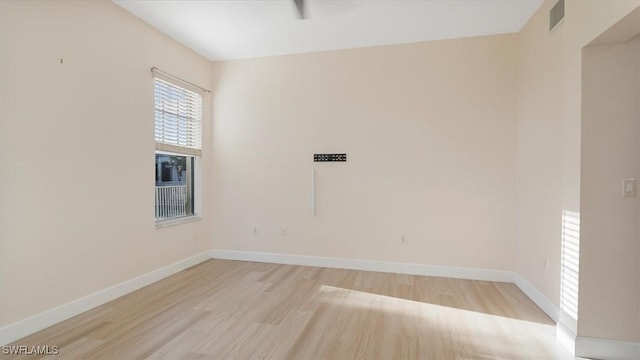 empty room with visible vents, baseboards, and light wood-style flooring