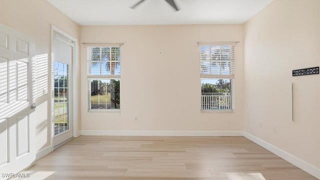 empty room with light wood-type flooring and baseboards