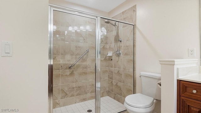 full bathroom with vanity, toilet, and a shower stall