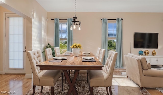 dining area with an inviting chandelier and light wood-style flooring