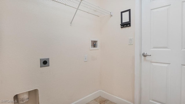 laundry area with laundry area, hookup for a washing machine, electric dryer hookup, and baseboards