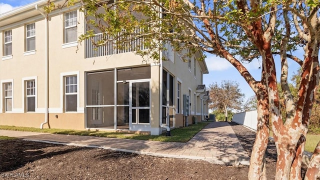 view of side of property with stucco siding