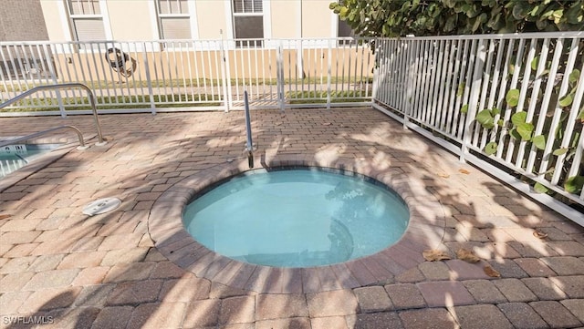 view of pool featuring a hot tub and fence