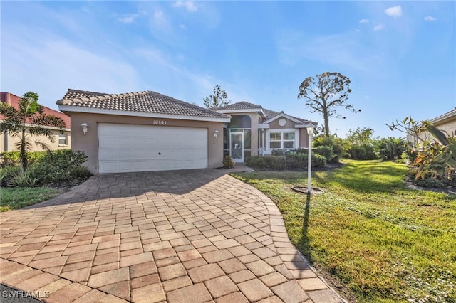 mediterranean / spanish-style house with a front yard and a garage