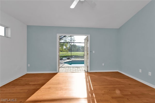 empty room with hardwood / wood-style flooring and ceiling fan