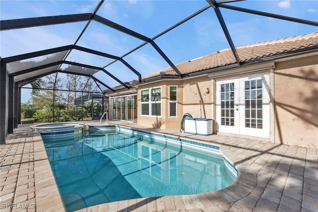 view of pool featuring an in ground hot tub, french doors, a patio, and glass enclosure