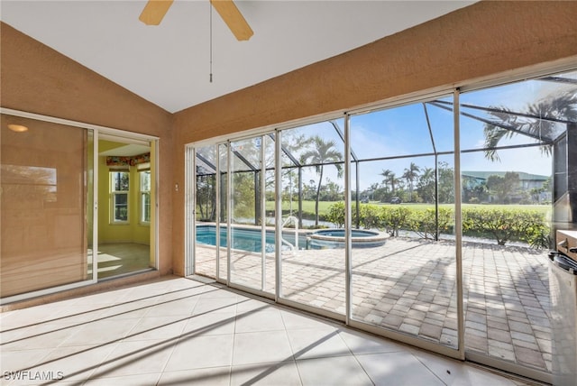 unfurnished sunroom featuring ceiling fan and vaulted ceiling