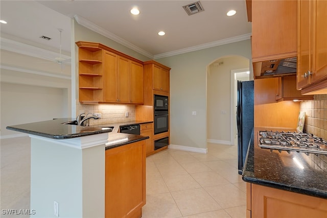 kitchen with sink, tasteful backsplash, kitchen peninsula, dark stone counters, and black appliances