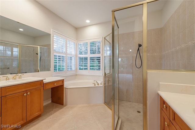 bathroom with tile patterned flooring, vanity, and shower with separate bathtub