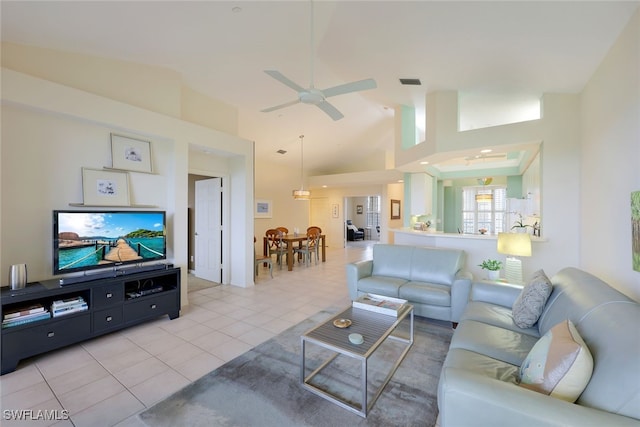 living room with ceiling fan, light tile patterned floors, and high vaulted ceiling