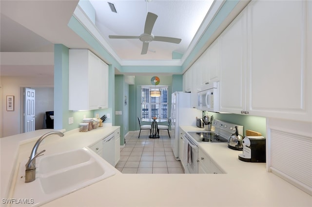 kitchen with white appliances, white cabinets, sink, ceiling fan, and light tile patterned flooring