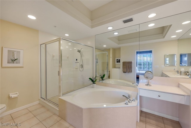 bathroom featuring a raised ceiling, tile patterned floors, vanity, and shower with separate bathtub