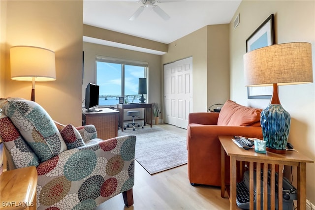 interior space with ceiling fan, visible vents, and wood finished floors