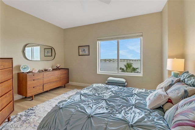 bedroom with light wood-style floors and baseboards