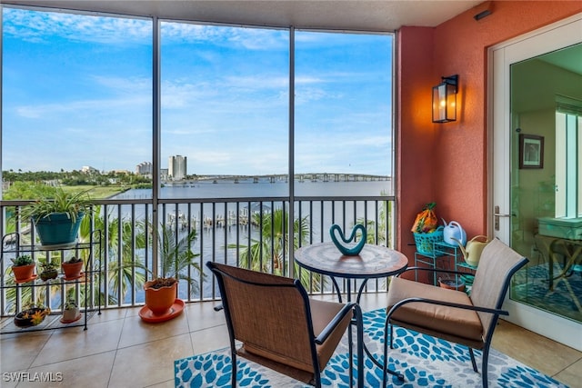 sunroom with a water view and a healthy amount of sunlight