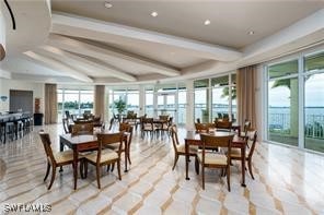 dining area featuring beamed ceiling